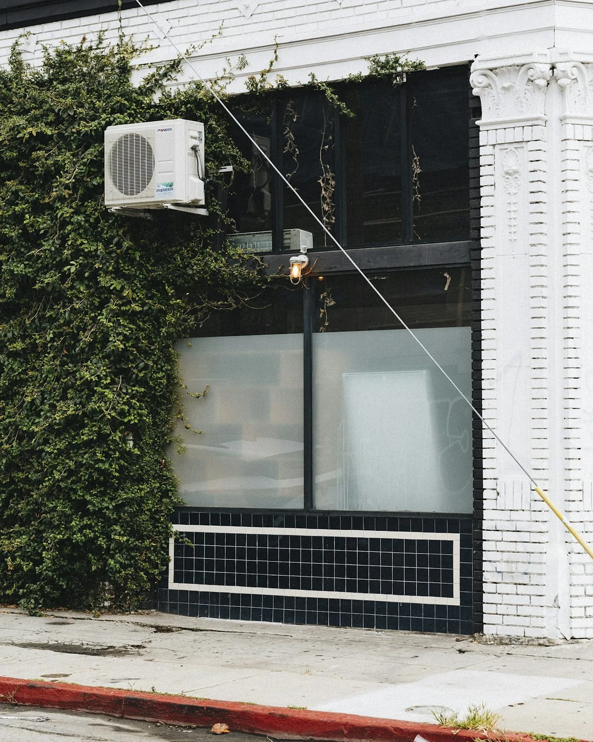 a white air conditioner sitting on the side of a building