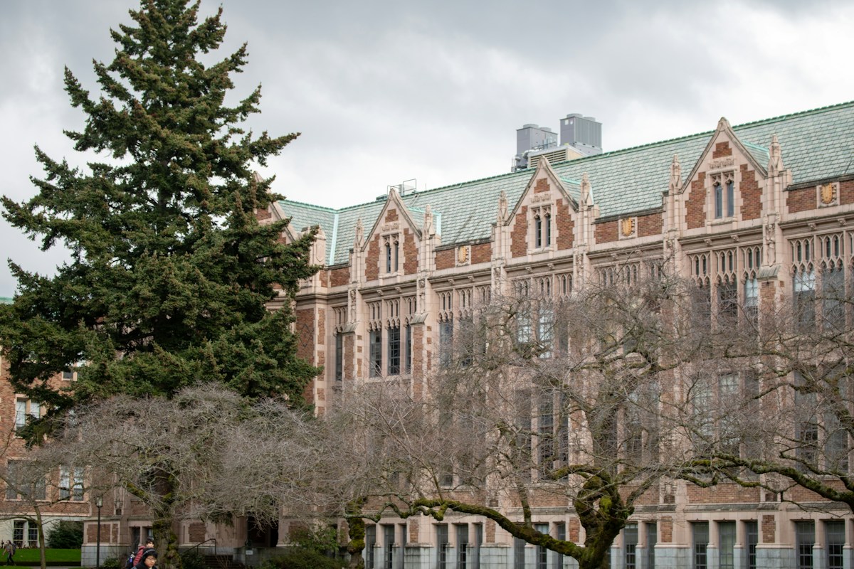 A university building sits beneath a cloudy sky